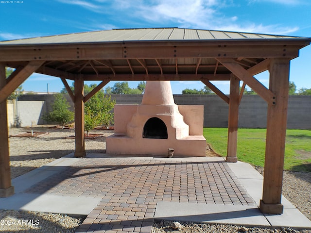 view of patio / terrace with a gazebo and exterior fireplace