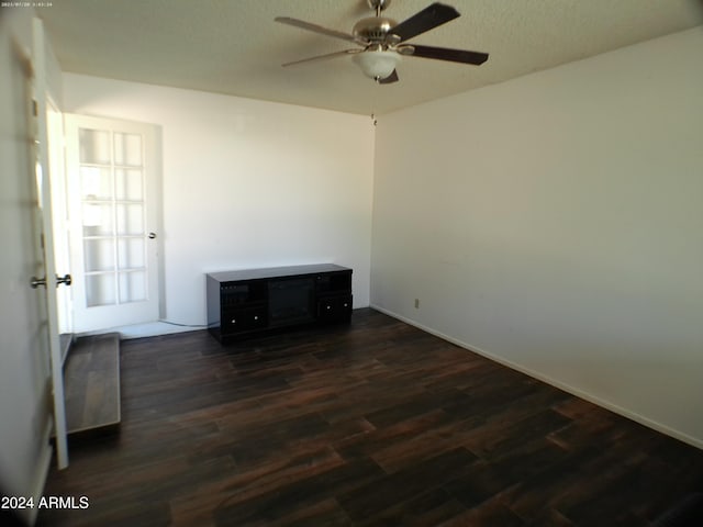 unfurnished room with ceiling fan, dark hardwood / wood-style flooring, and a textured ceiling