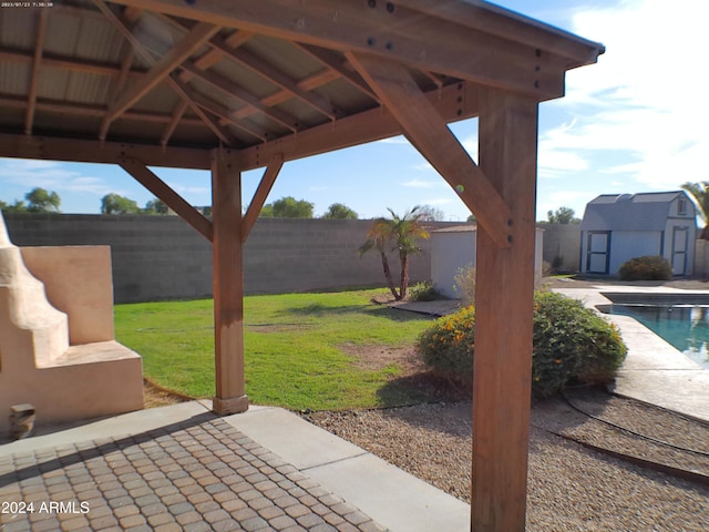 view of patio / terrace with a gazebo, a shed, and a fenced in pool