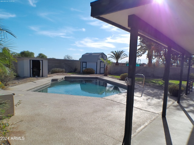 view of pool featuring a storage unit and a patio area