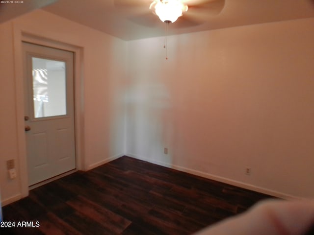 foyer entrance with ceiling fan and dark wood-type flooring