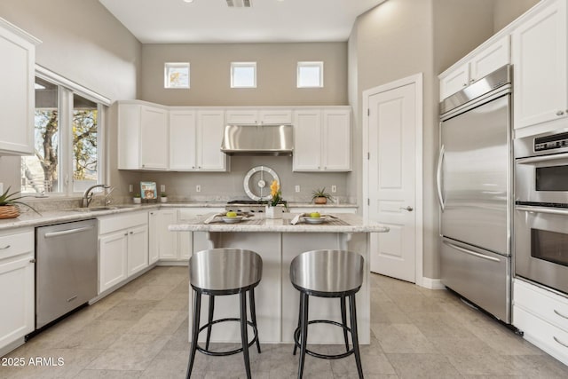 kitchen featuring white cabinetry, a kitchen island, and appliances with stainless steel finishes