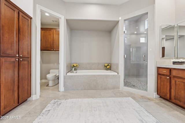 full bathroom featuring vanity, tile patterned flooring, shower with separate bathtub, and toilet