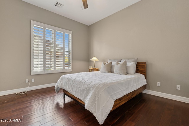 bedroom with dark hardwood / wood-style floors and ceiling fan