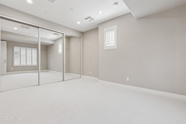 unfurnished bedroom featuring carpet floors and a closet