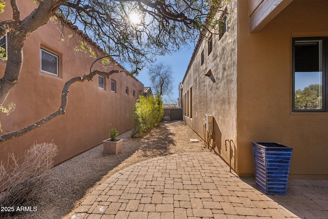 view of side of property featuring a patio area