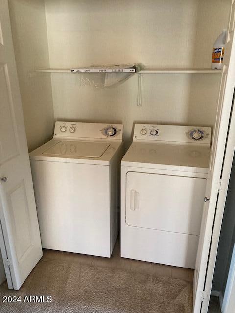 clothes washing area featuring washer and dryer