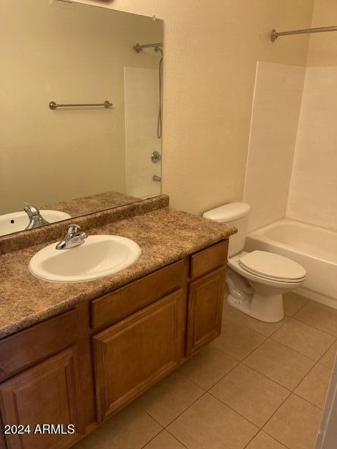 full bathroom with toilet, vanity, tile patterned floors, and  shower combination