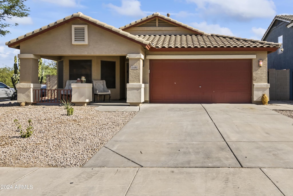 view of front of property featuring a garage and a porch