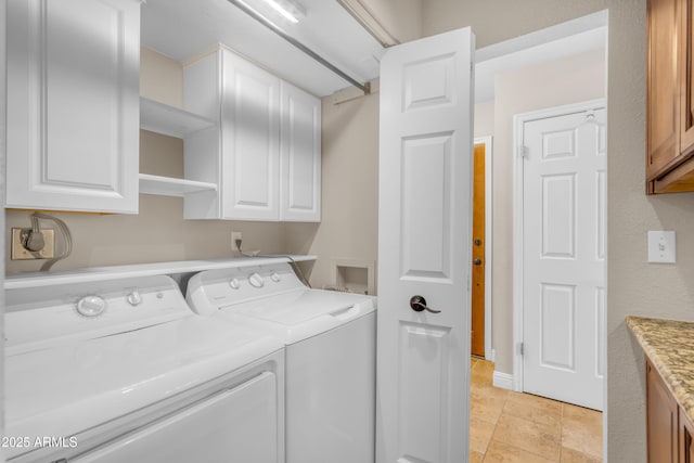 clothes washing area featuring cabinet space and washing machine and clothes dryer