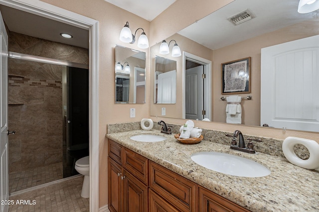 full bath with toilet, a stall shower, a sink, and visible vents