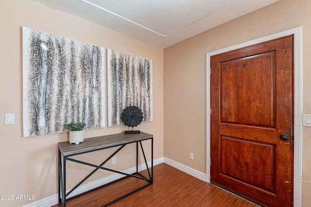 foyer with wood finished floors and baseboards