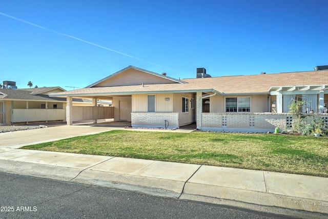 single story home featuring a front yard and a carport