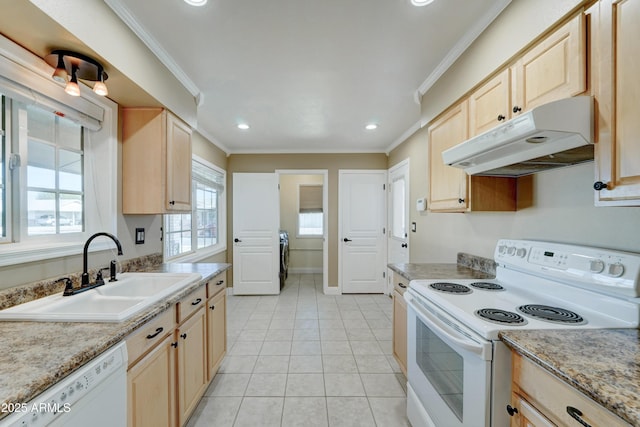 kitchen with light brown cabinetry, sink, and white appliances