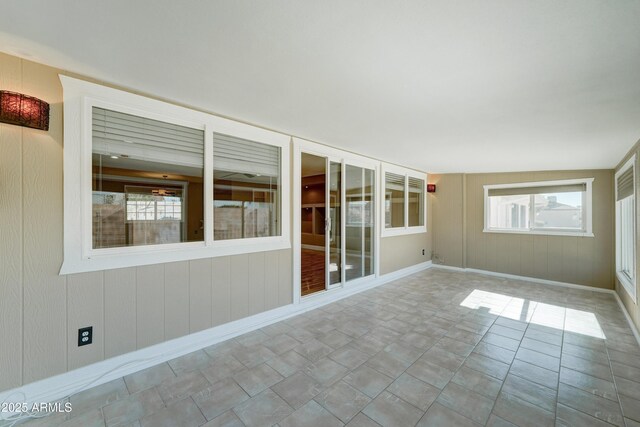 unfurnished sunroom with a wealth of natural light