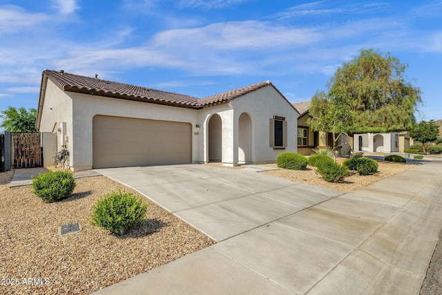 4595 W Foldwing Dr, San Tan Valley, AZ 85144 - mediterranean / spanish-style house with stucco siding, a gate, driveway, and a tile roof