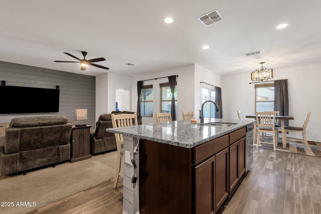4595 W Foldwing Dr, San Tan Valley, AZ 85144 - kitchen featuring a sink, light wood-style floors, dishwasher, a chandelier, and ceiling fan