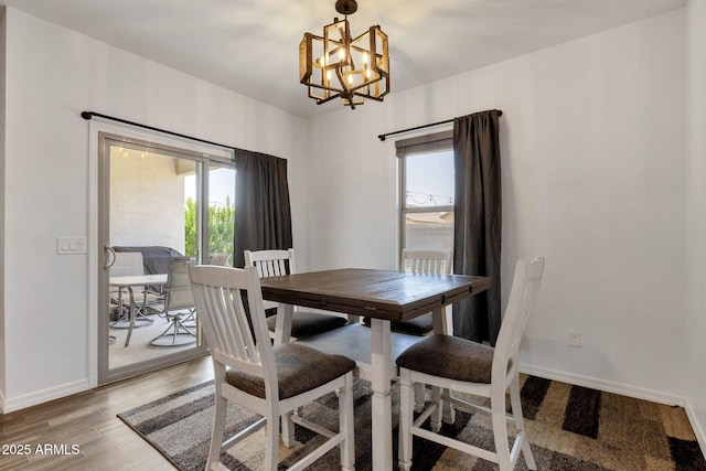 4595 W Foldwing Dr, San Tan Valley, AZ 85144 - dining space featuring a chandelier, baseboards, and light wood-style flooring