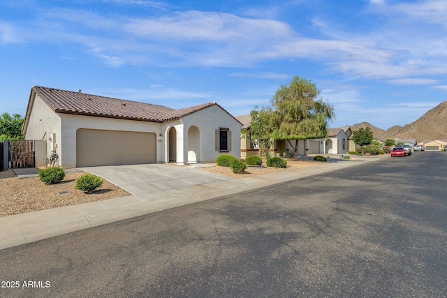 4595 W Foldwing Dr, San Tan Valley, AZ 85144 - mediterranean / spanish house featuring stucco siding, a tiled roof, an attached garage, and concrete driveway