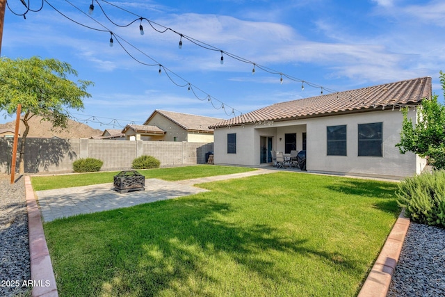4595 W Foldwing Dr, San Tan Valley, AZ 85144 - back of property with a tile roof, a patio, stucco siding, and an outdoor fire pit