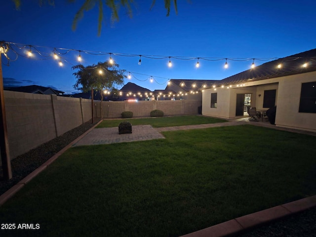 4595 W Foldwing Dr, San Tan Valley, AZ 85144 - yard at night featuring a patio area