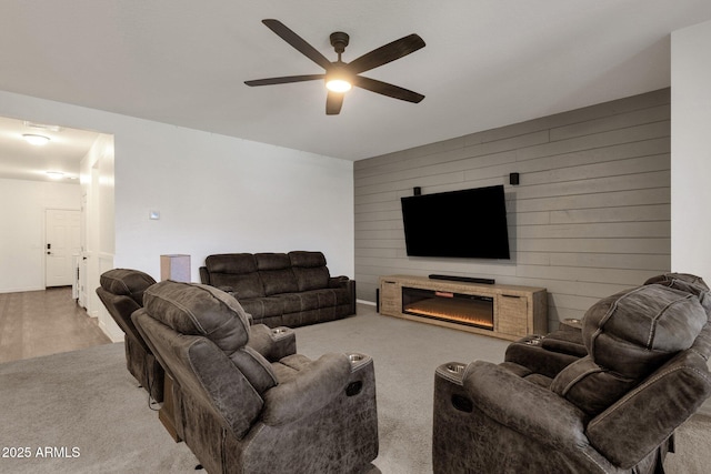 4595 W Foldwing Dr, San Tan Valley, AZ 85144 - living room with ceiling fan, wood walls, carpet flooring, and a glass covered fireplace