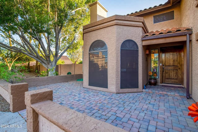 entrance to property with a patio