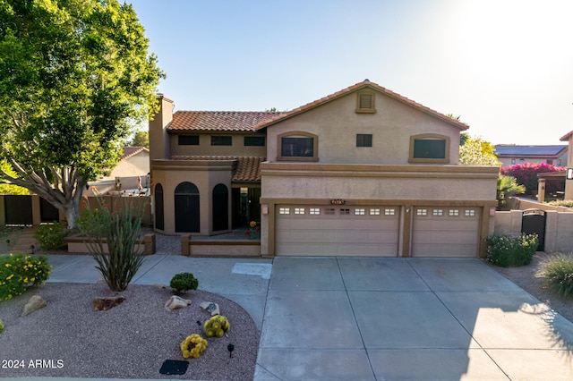 mediterranean / spanish home featuring a garage