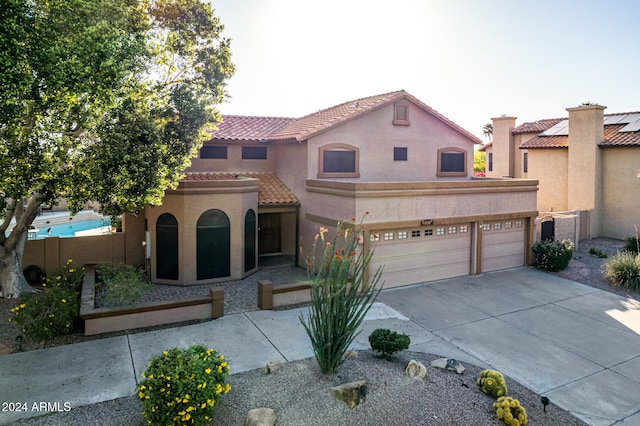 mediterranean / spanish-style home with a garage