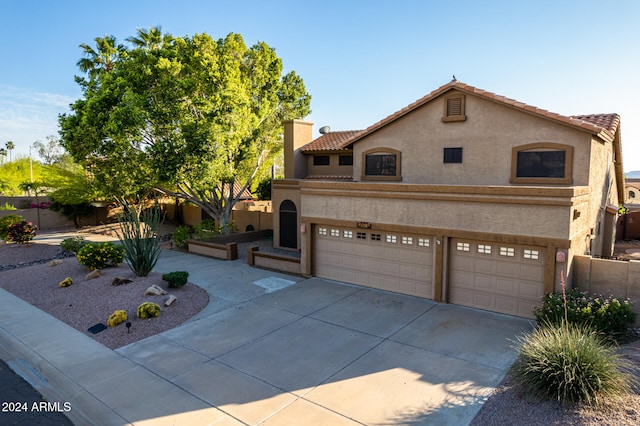 mediterranean / spanish-style house with a garage