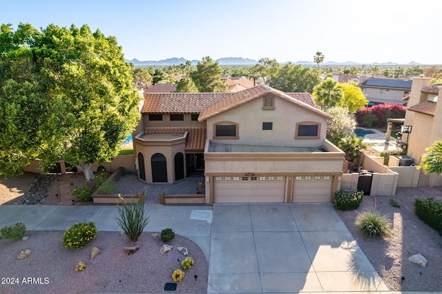 mediterranean / spanish home featuring a mountain view and a garage