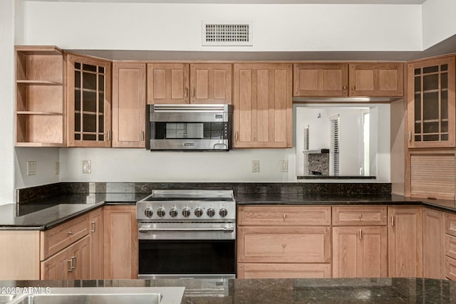 13128 N 104th Pl, Scottsdale, AZ 85260 - kitchen with appliances with stainless steel finishes, open shelves, dark stone counters, glass insert cabinets, and light brown cabinetry