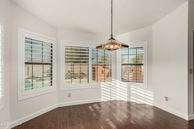 13128 N 104th Pl, Scottsdale, AZ 85260 - unfurnished dining area featuring dark wood-type flooring and baseboards