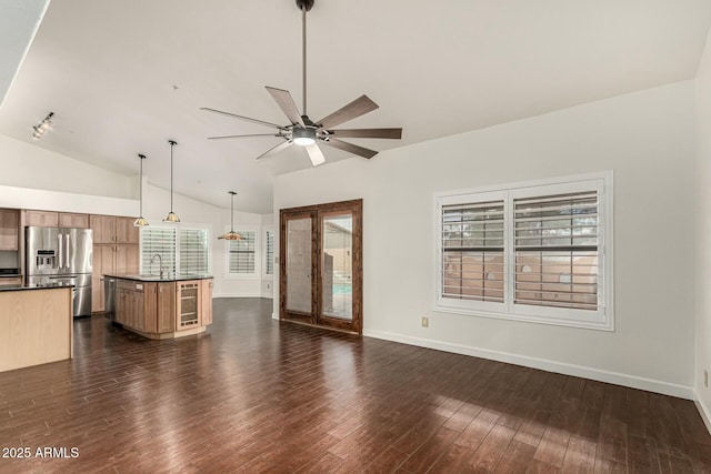 13128 N 104th Pl, Scottsdale, AZ 85260 - unfurnished living room with a ceiling fan, beverage cooler, dark wood-style floors, vaulted ceiling, and healthy amount of natural light