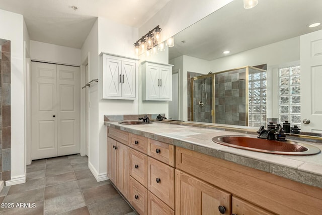 13128 N 104th Pl, Scottsdale, AZ 85260 - full bath with double vanity, a stall shower, baseboards, and a closet