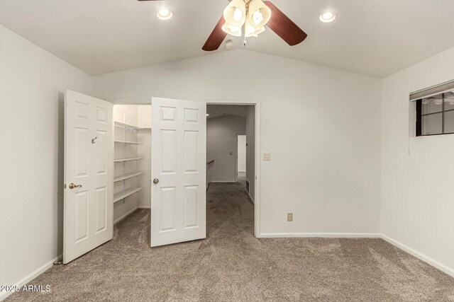 13128 N 104th Pl, Scottsdale, AZ 85260 - unfurnished bedroom featuring light colored carpet, lofted ceiling, a walk in closet, baseboards, and a ceiling fan