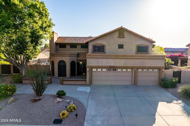 13128 N 104th Pl, Scottsdale, AZ 85260 - mediterranean / spanish house with stucco siding, a garage, driveway, a tile roof, and a chimney