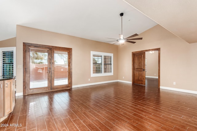 unfurnished living room featuring dark wood-type flooring, ceiling fan, lofted ceiling, and french doors