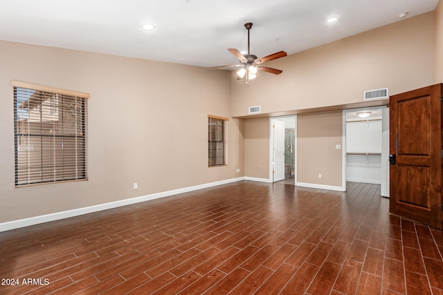 spare room featuring ceiling fan, dark hardwood / wood-style flooring, and high vaulted ceiling