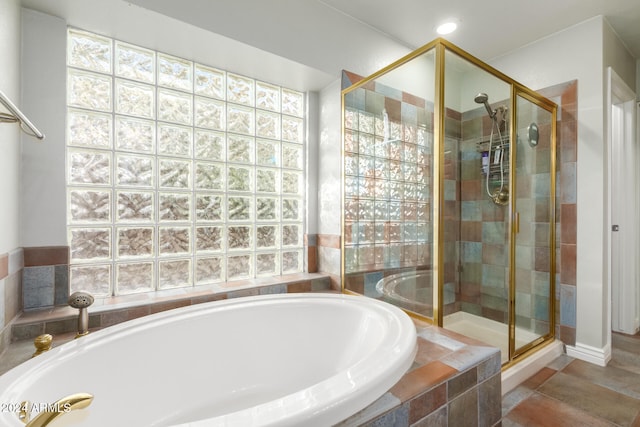 bathroom featuring tile patterned flooring, shower with separate bathtub, and plenty of natural light