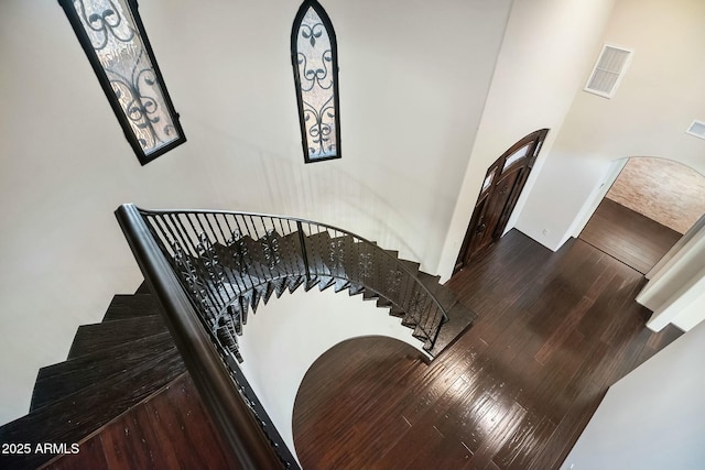 stairway with hardwood / wood-style flooring and visible vents