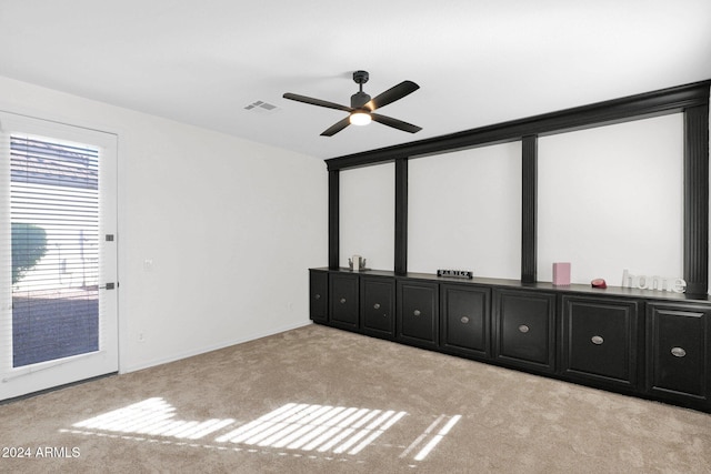 unfurnished bedroom featuring light colored carpet and ceiling fan