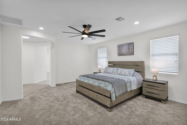 bedroom featuring light colored carpet and ceiling fan