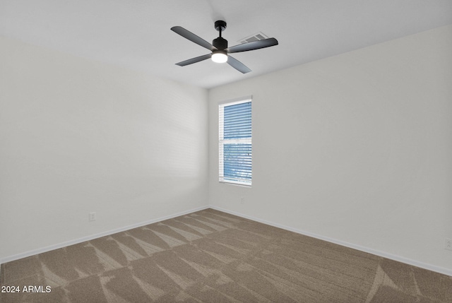 unfurnished room with ceiling fan and carpet floors