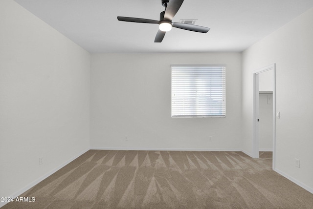 unfurnished room featuring light carpet and ceiling fan