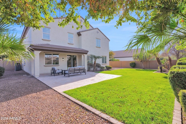 back of house featuring an outdoor hangout area, a patio area, and a yard