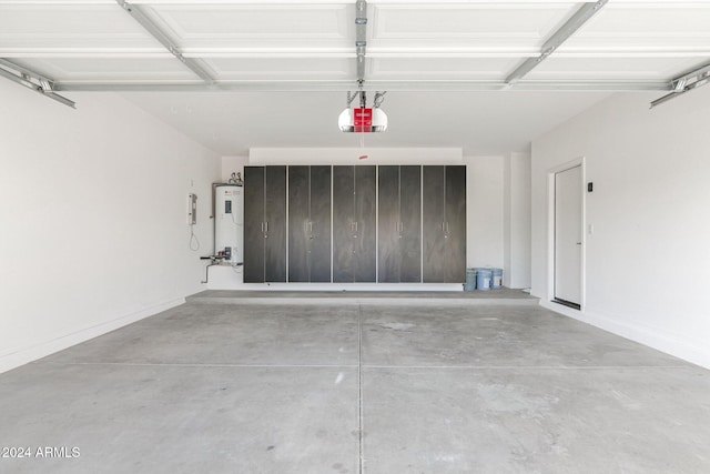 garage featuring water heater and a garage door opener