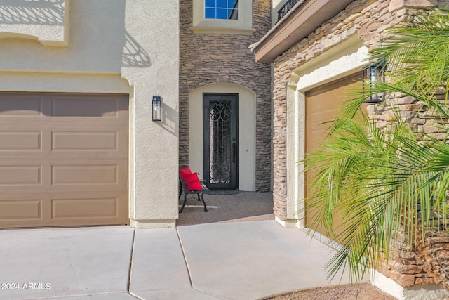 view of exterior entry featuring a garage