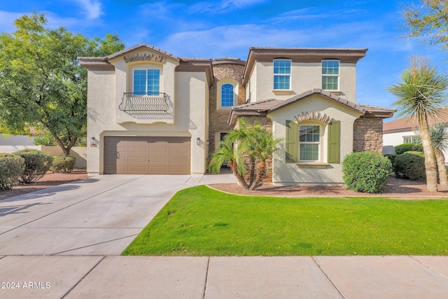 mediterranean / spanish house featuring a garage and a front lawn