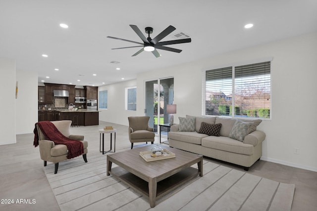 living room with ceiling fan and sink